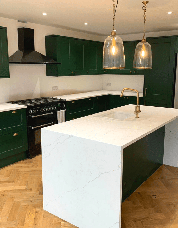 green kitchen with quartz island